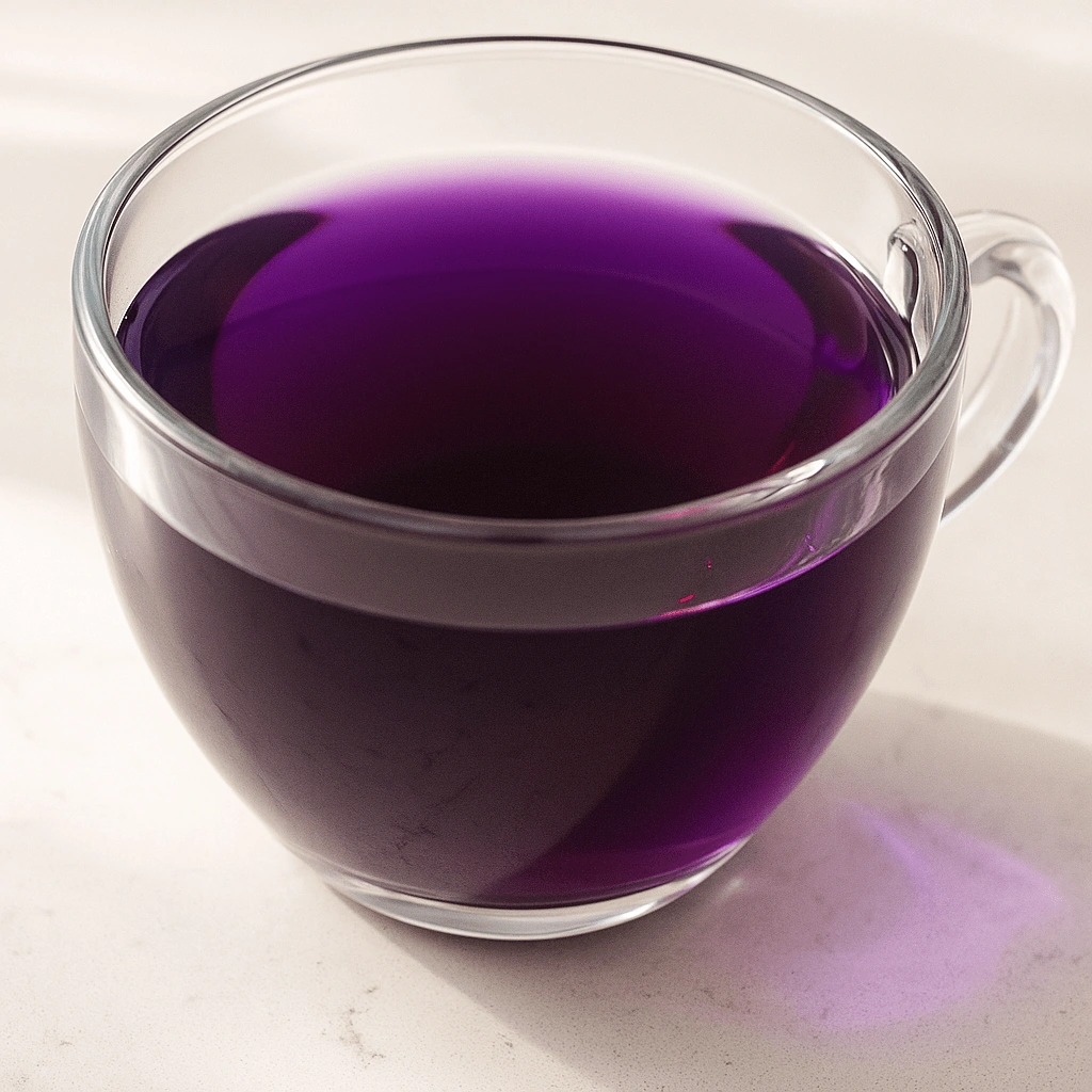 Glass cup of purple butterfly pea flower tea on a light surface, Natural Mounjaro Recipe style.