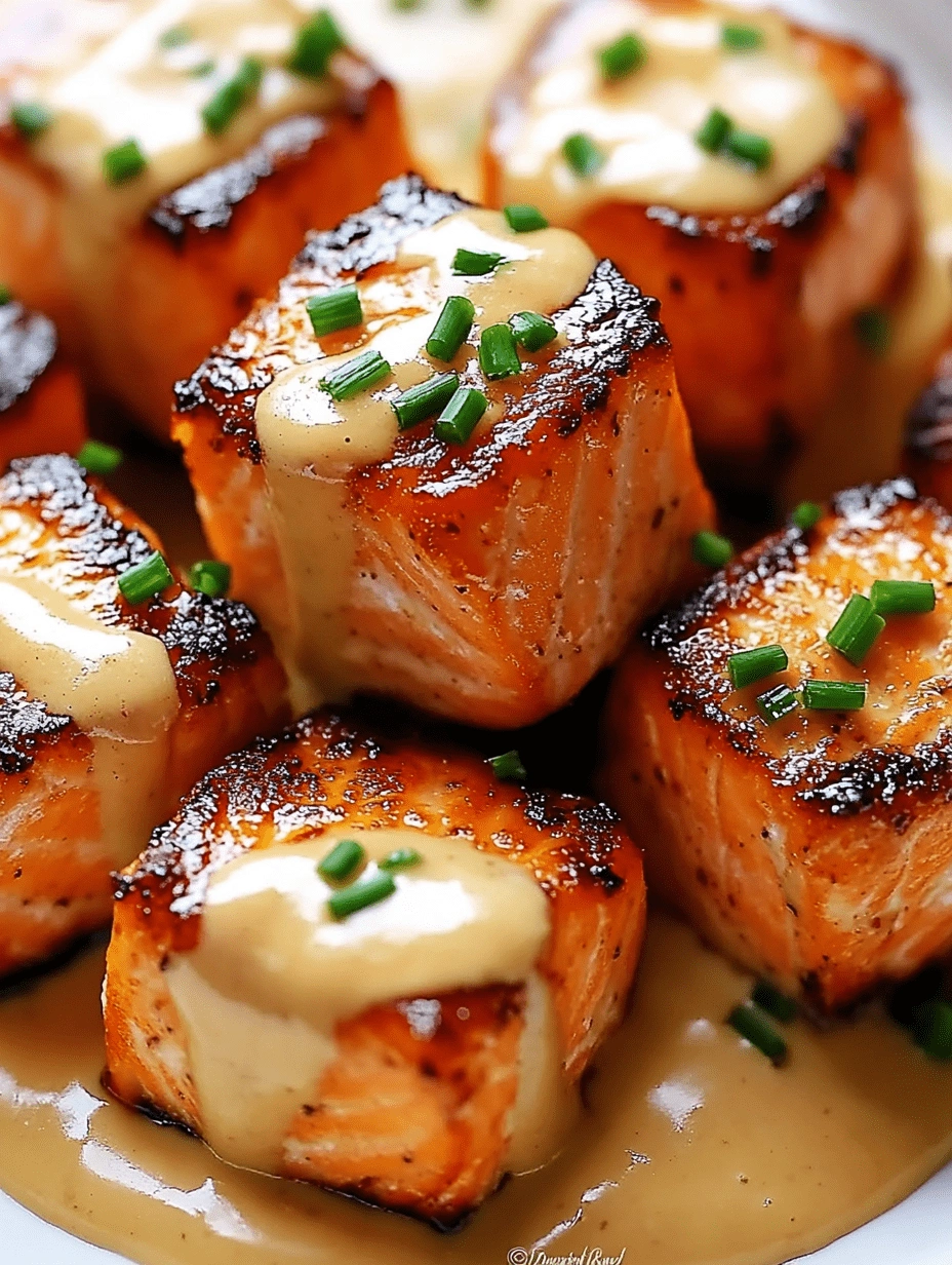 Crispy salmon bites stacked and topped with Bang Bang sauce and fresh chives