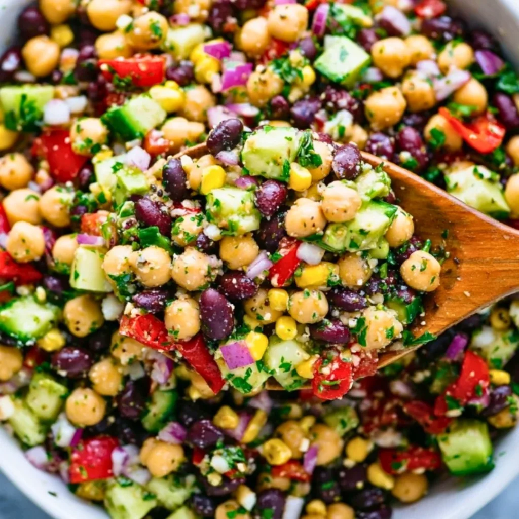 A bright, fizzy blue beverage with granulated salt crystals and a clear jar on a granite surface.