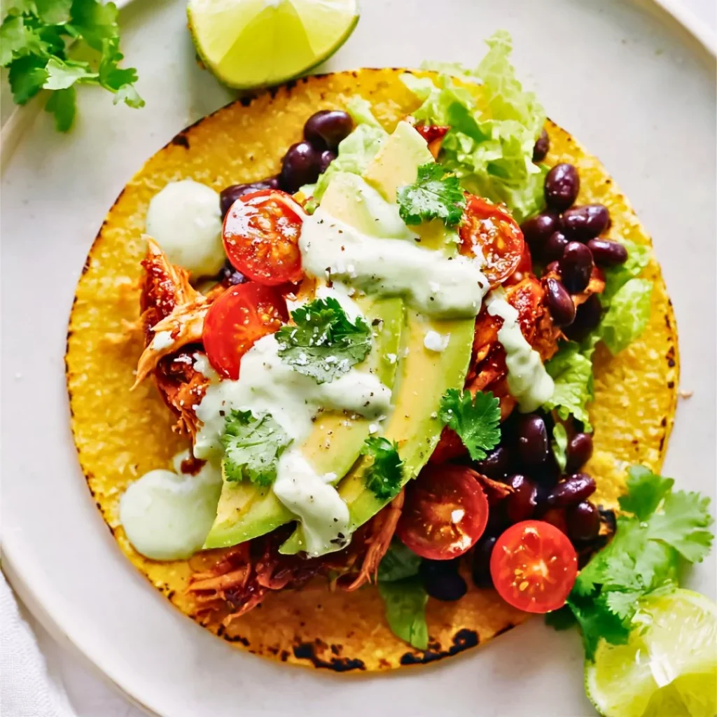 A bright, fizzy blue beverage with granulated salt crystals and a clear jar on a granite surface.