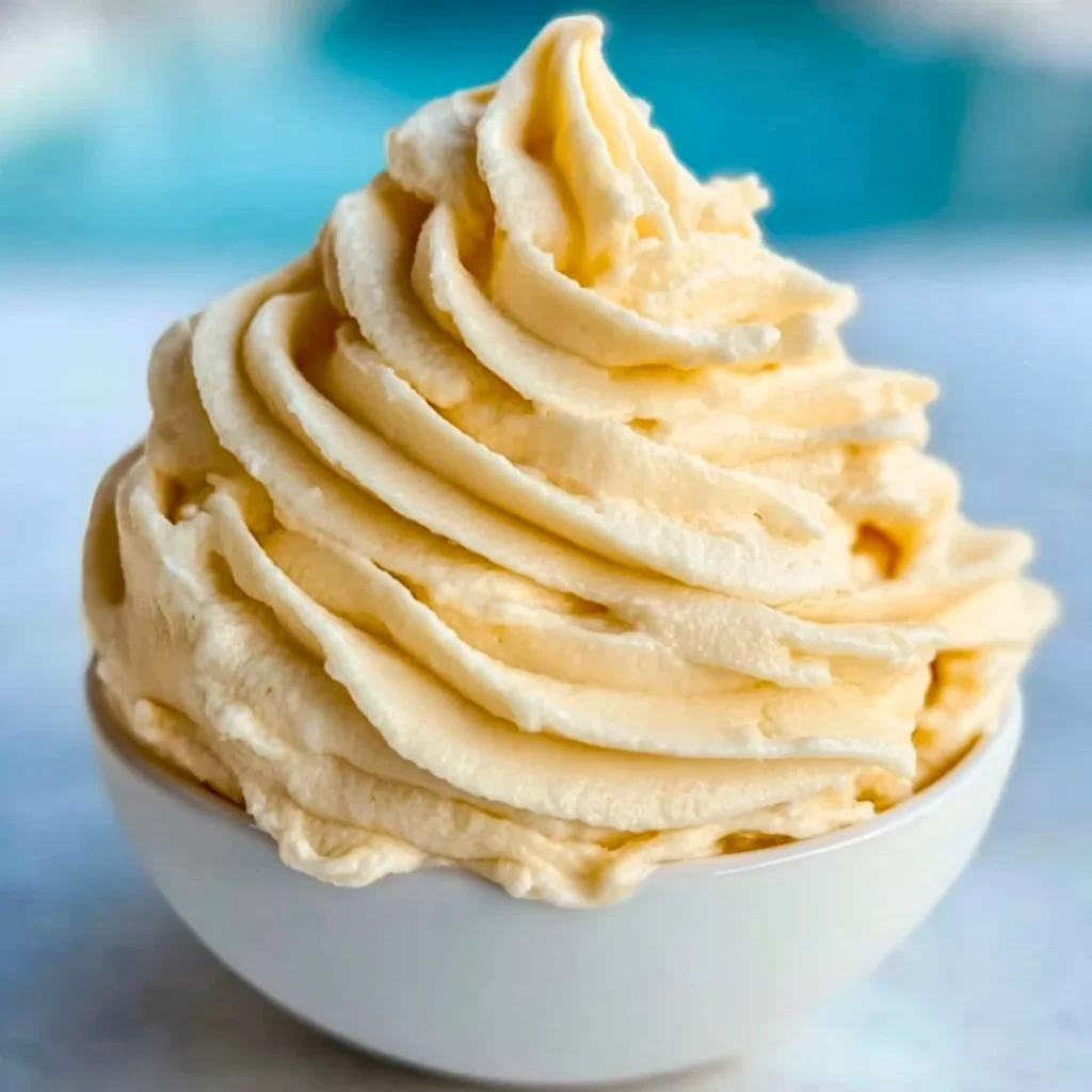 A bright, fizzy blue beverage with granulated salt crystals and a clear jar on a granite surface.