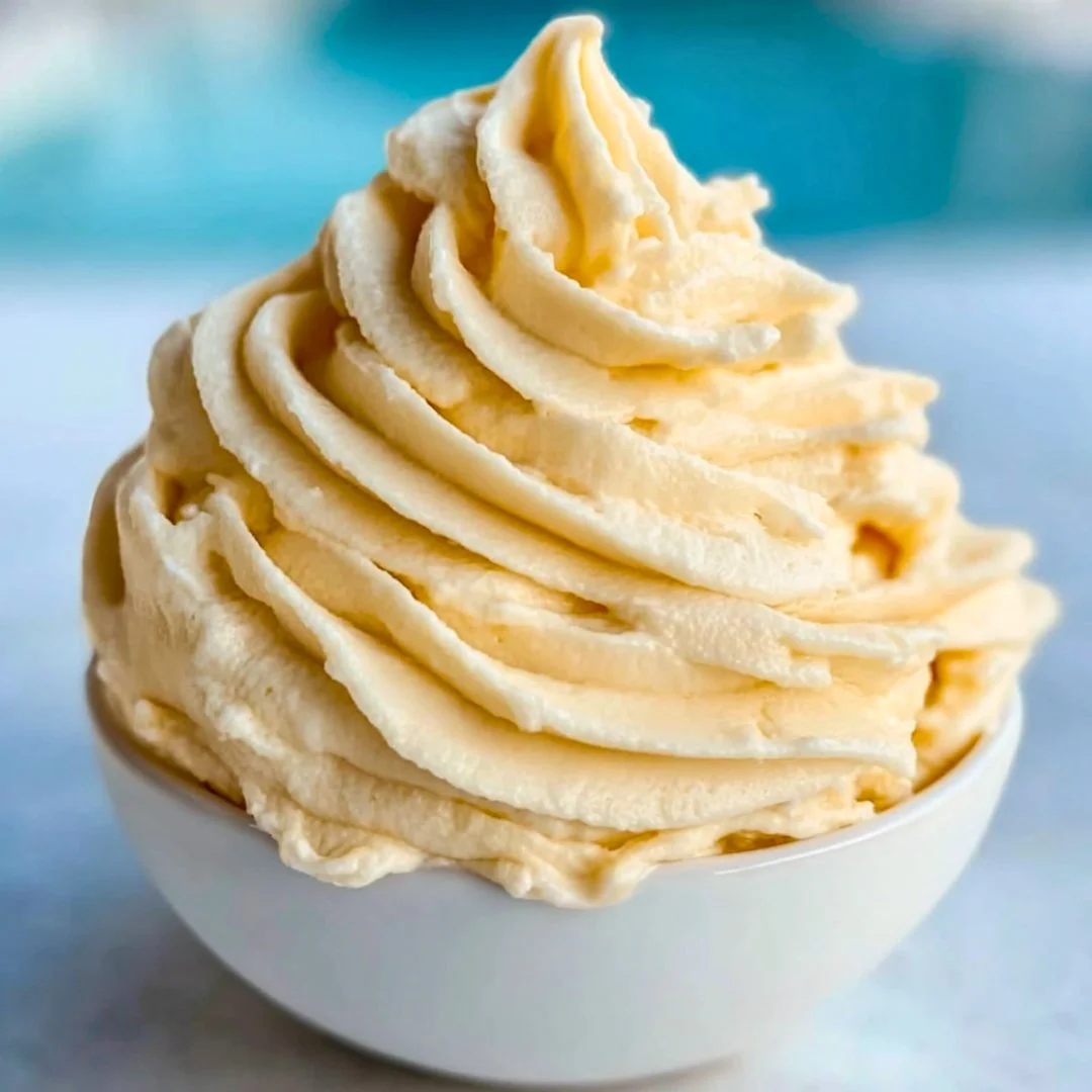 A bright, fizzy blue beverage with granulated salt crystals and a clear jar on a granite surface.