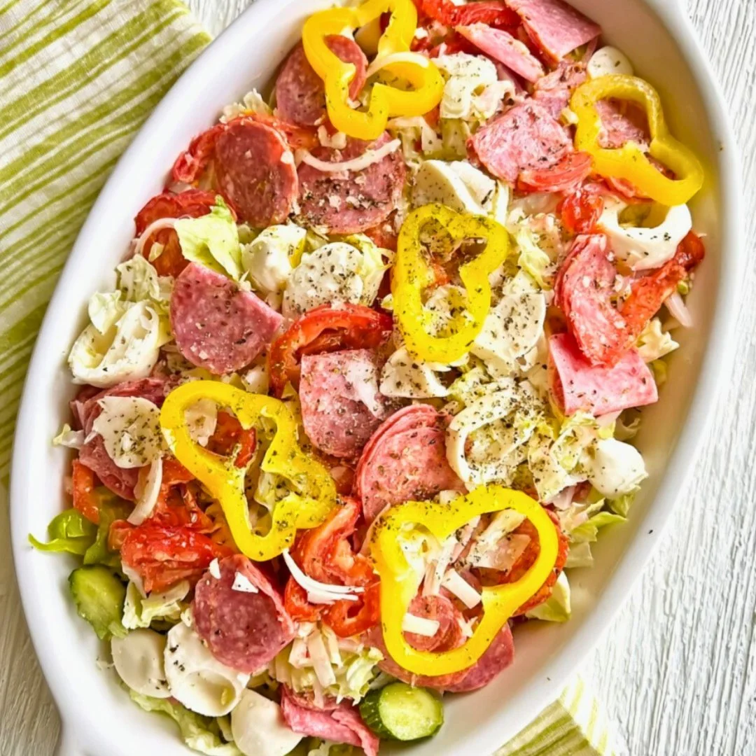 Two variations of Italian Sub Salad served in bowls with fresh ingredients