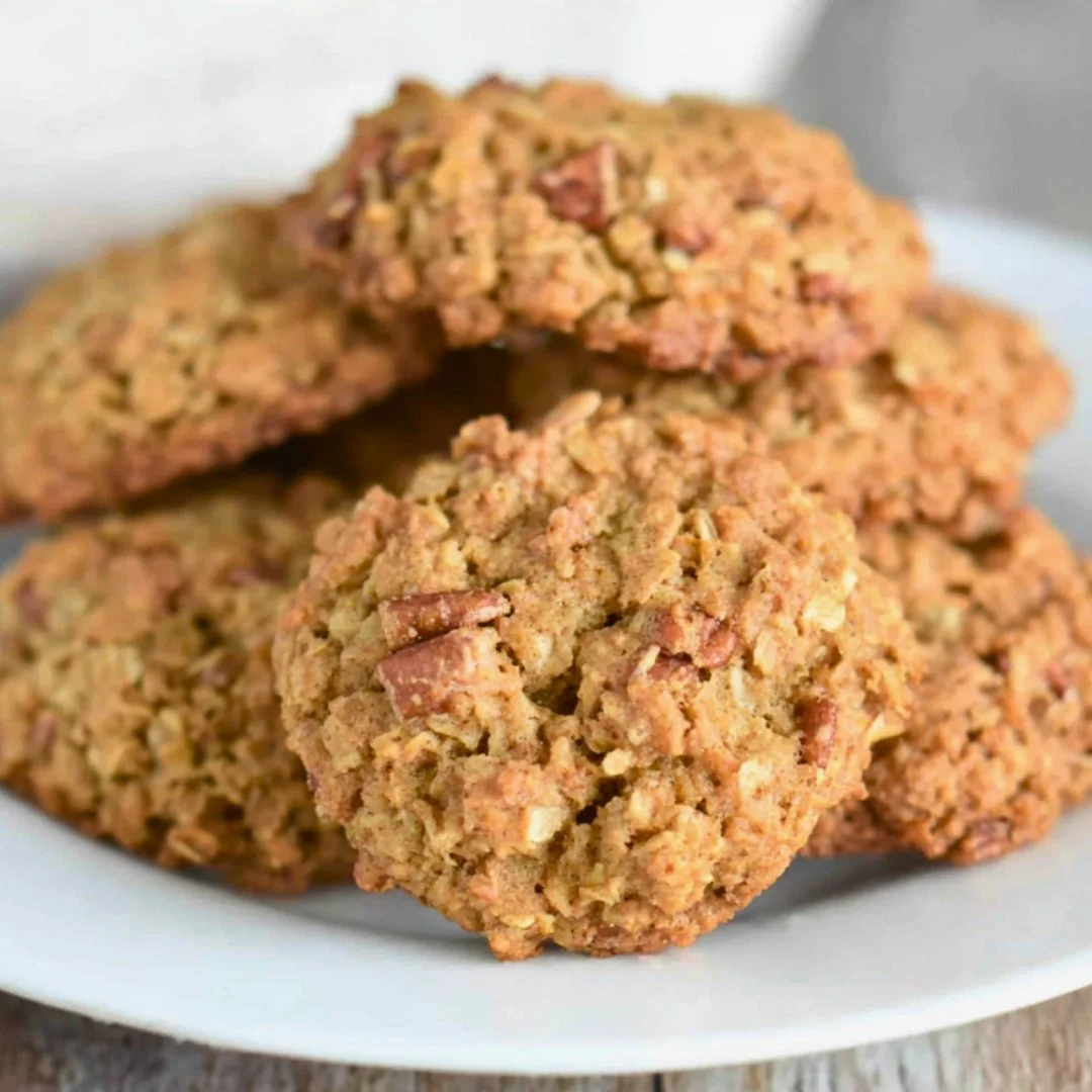Plate of homemade Oatmeal Coconut Pecan Cookies with a rustic background