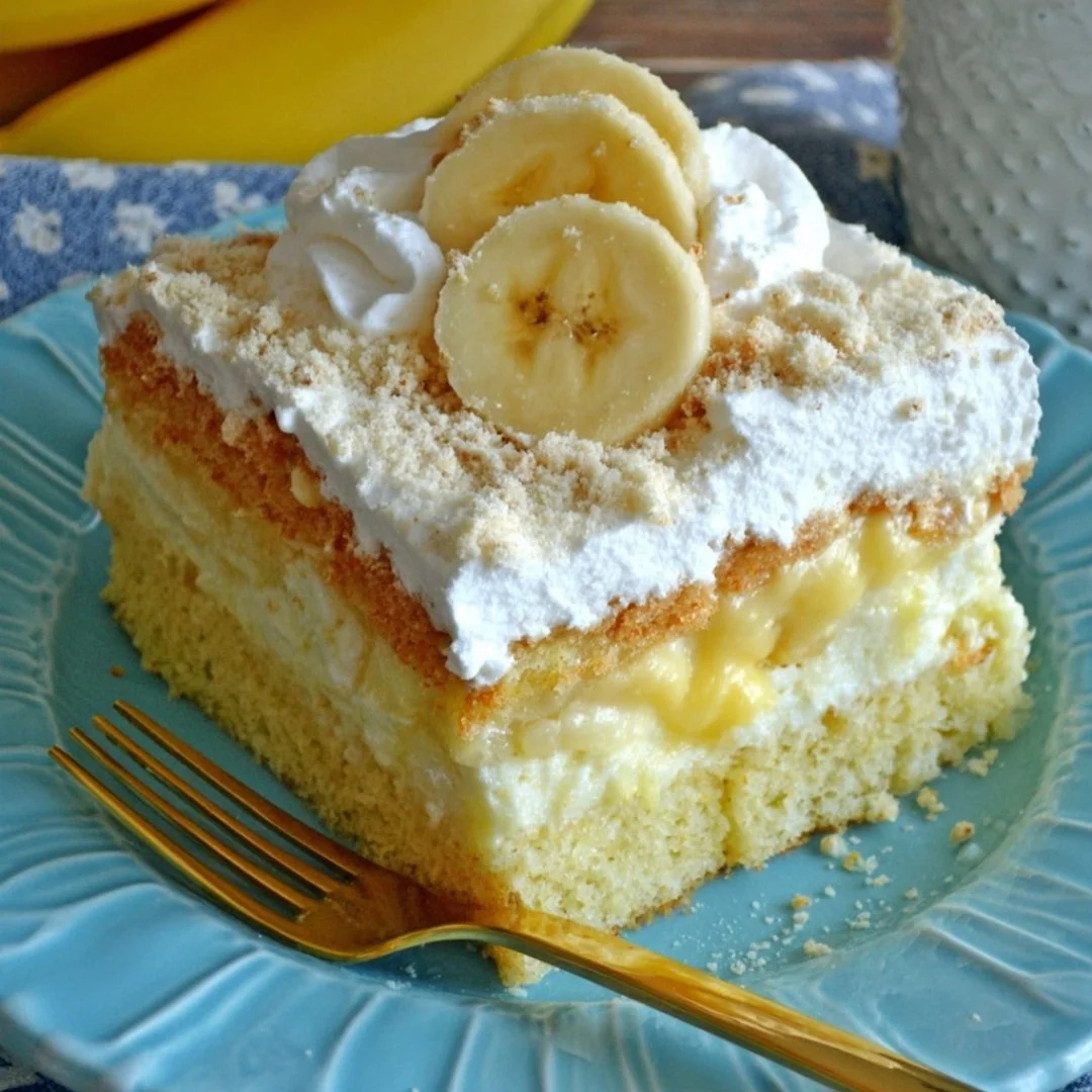 Delicious banana pudding poke cake topped with whipped cream and banana slices.