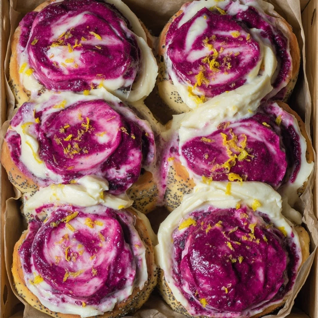 Freshly baked Blueberry Lemon Poppy Seed Rolls on a cooling rack