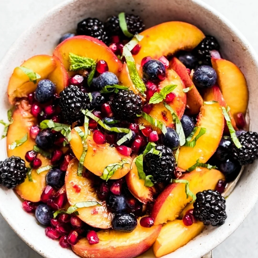 Honey lime basil peach fruit salad served in a bowl