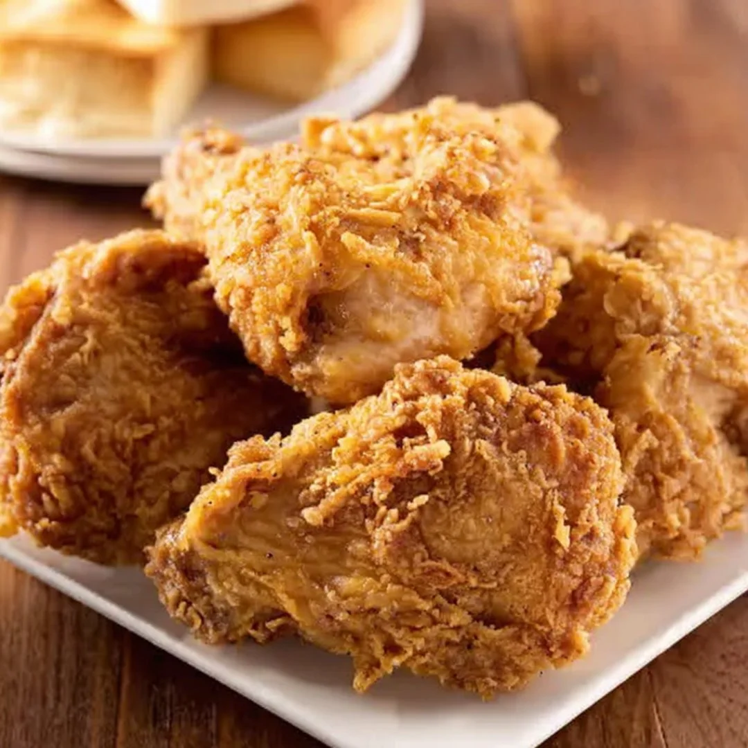 Crispy oven fried chicken served with sides on a plate